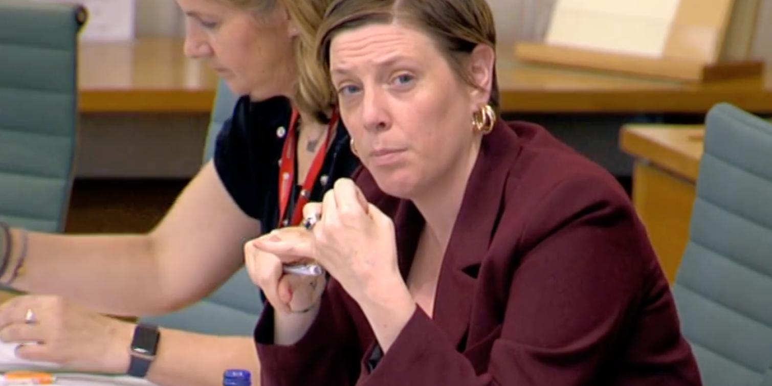 Jess sitting in a committee meeting